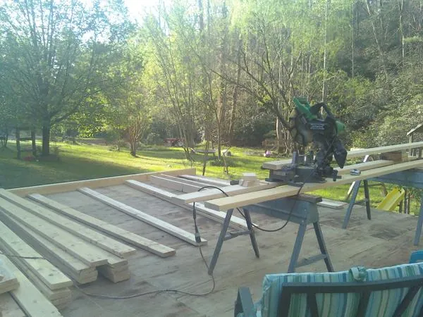 Miter saw and framing lumber on a deck under construction in Abilene